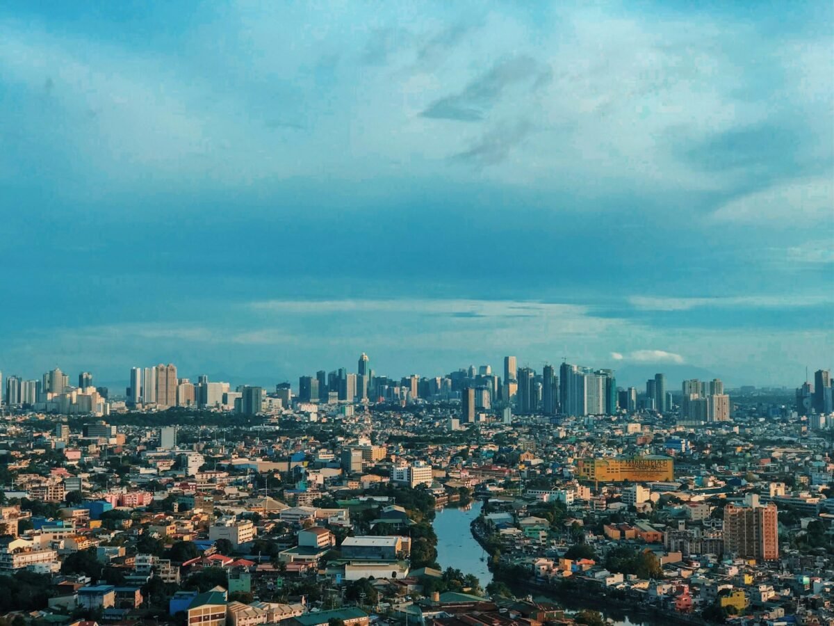 Modern city skyline in the Philippines under a blue sky