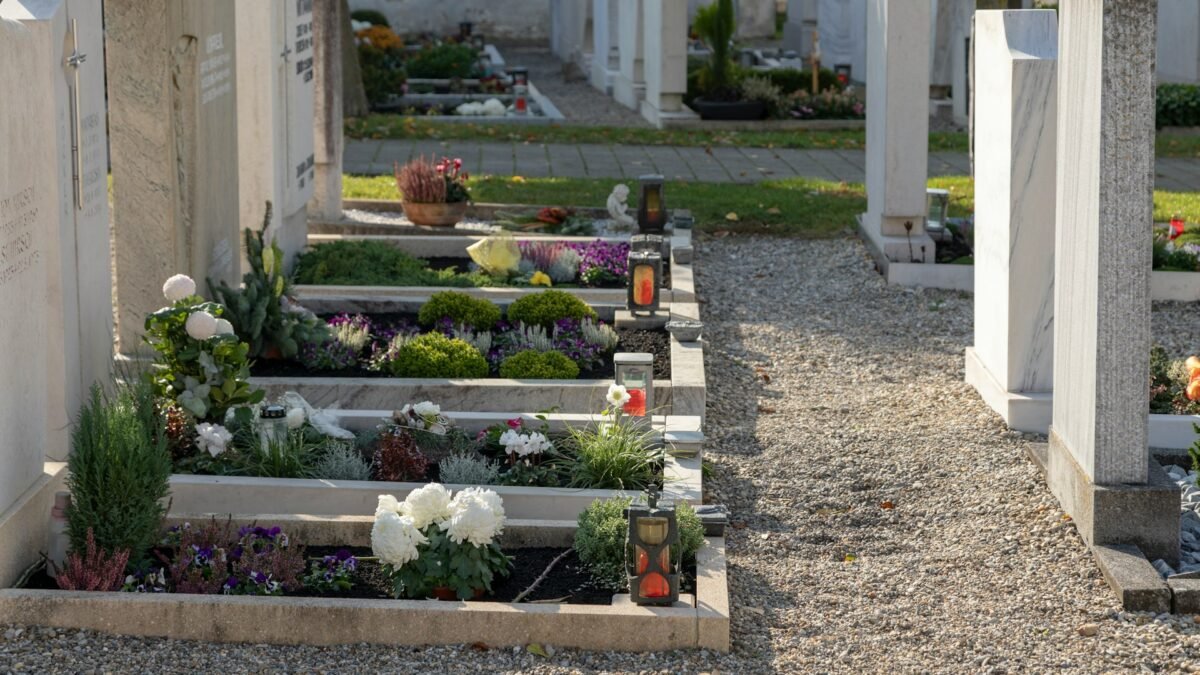 Graves decorated with flowers and candles on All Saints Day